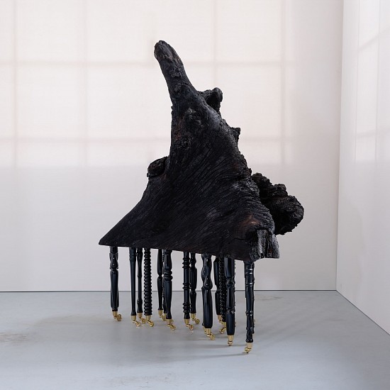 DIANA VIVES, A FURTHER SHORE
2023, ROOT OF A RED RIVER GUM BURNT IN A WILDFIRE, ON 20 TURNED AND LAQUERED BEECHWOOD LEGS, EACH FITTED WITH BRASS PIANO CASTORS